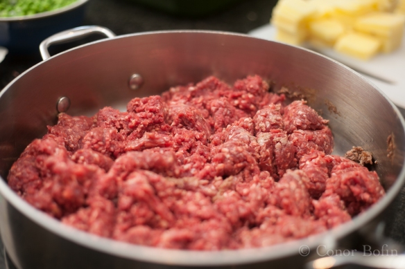 The mince meat in the pan being browned. 