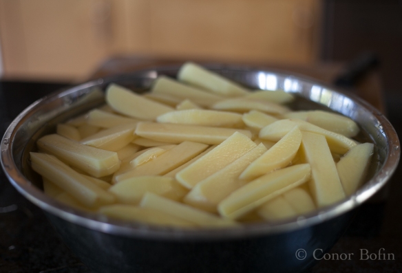 Soak the chips (fries) in a big bowl of water. 