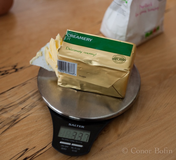 The butter will weigh less without the foil. 